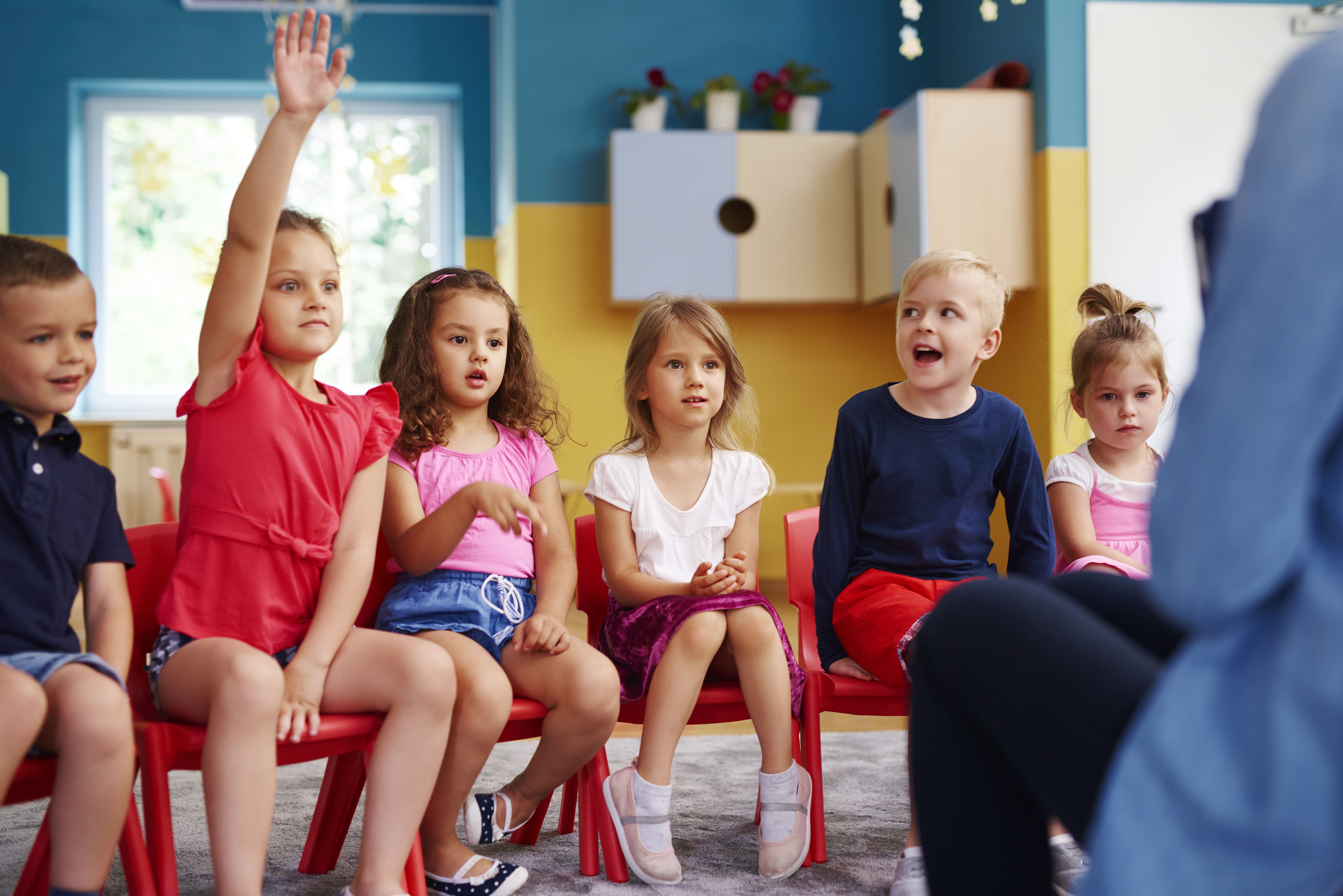 Girl raising hand in classroom